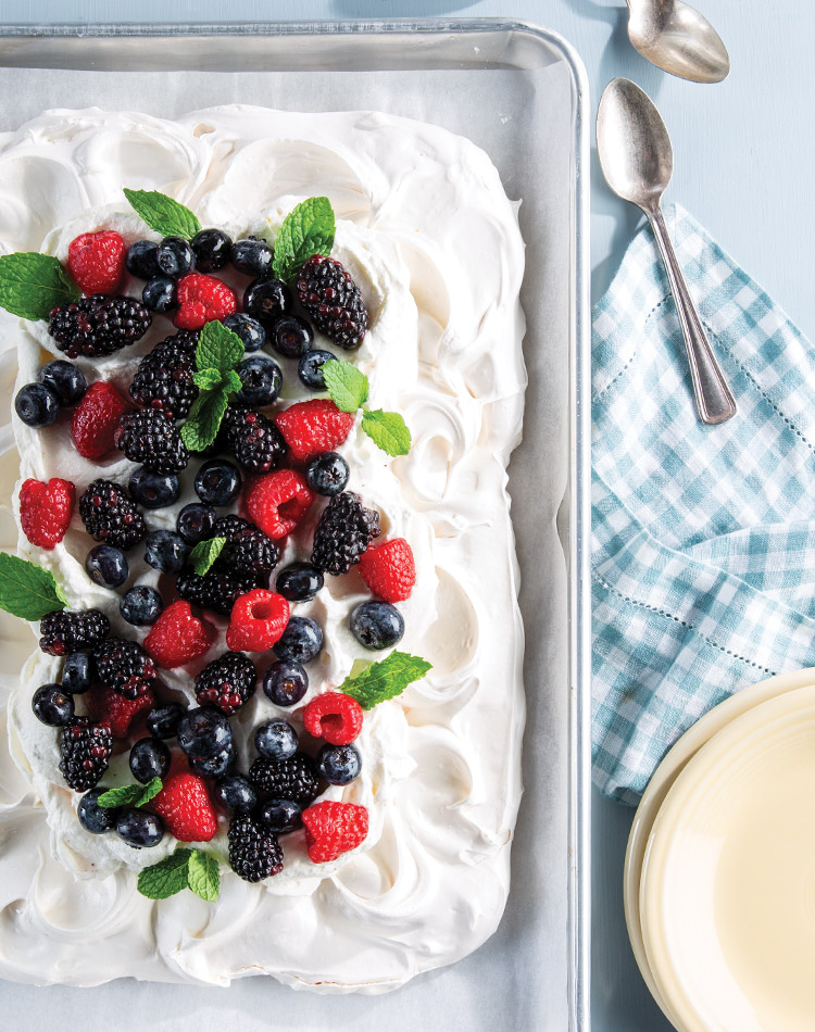 Our Sheet Pan Pavlova with Lavender Berries, drizzled with fragrant lavender simple syrup, is a whimsical twist on a classic dessert.