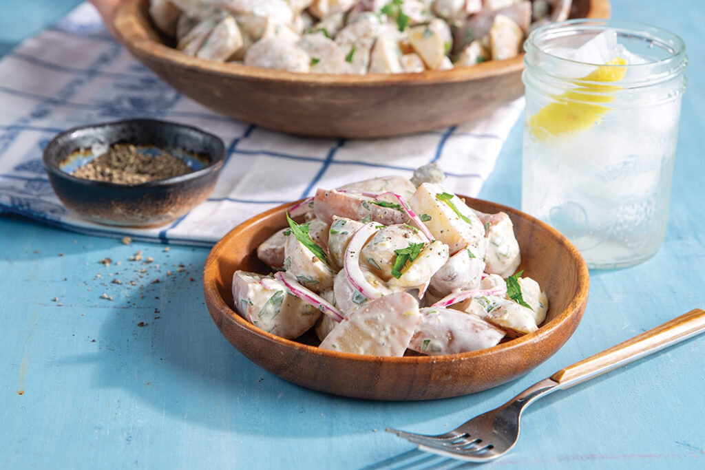This classic Southern side of Creamy Potato Salad is bright and beautiful with the addition of Champagne vinegar, lemon zest and juice, and chopped cornichons.