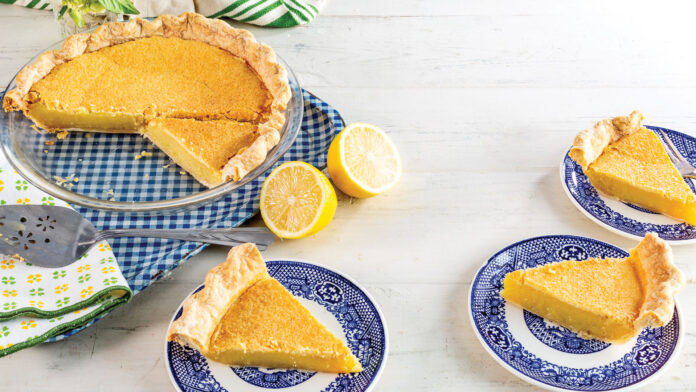 New Ways with Chess Pie Chess Pie with three slices taken out on plates and lemons
