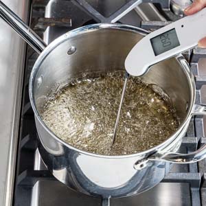 Taking temperature of sugar mixture