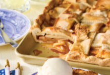 Sheet Pan Lattice Apple Pie Sheet pan apple pie with a lattice crust topped with a scoop of vanilla ice cream.