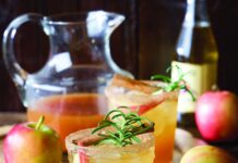 Fizzy Apple Cider fizzy apple cider with apple, rosemary, and cinnamon stick garnish