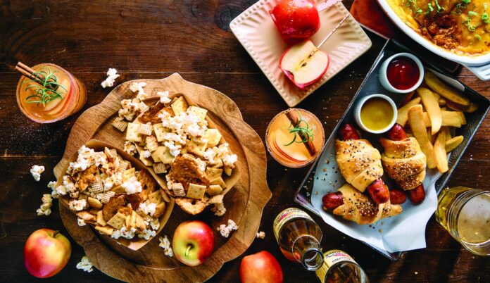 popcorn snack mix, candy apples, cheesy dip, pigs in a blanket